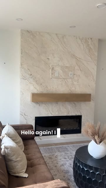 Cream marble Venetian plaster media wall above a linear fireplace