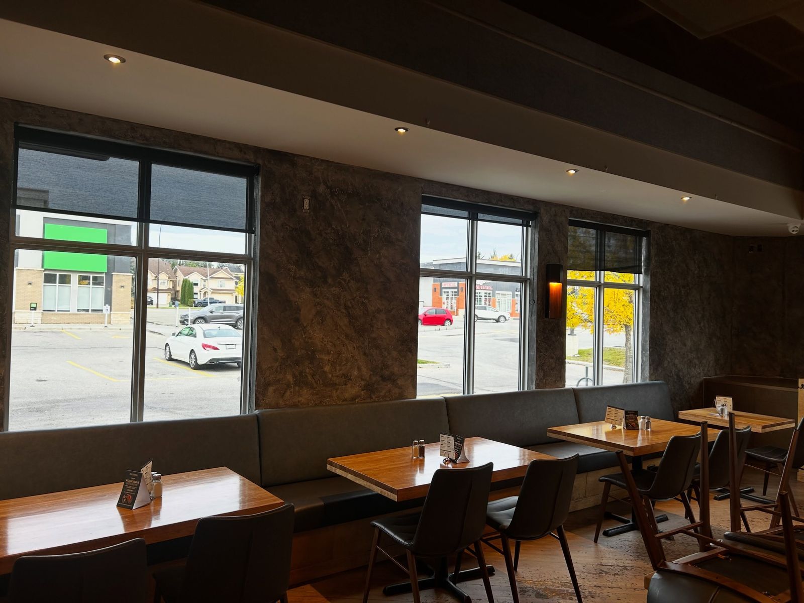 Long restaurant banquette below deep, cloudy Venetian plaster walls
