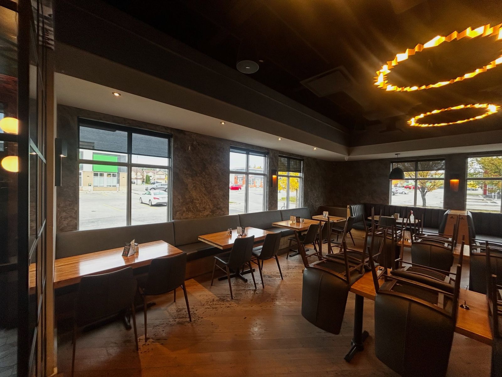 Restaurant dining room with Venetian plaster walls and warm ring pendant lights